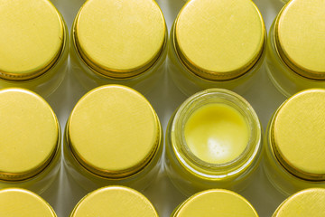 herbal balm in glass pot with gold cap, top view