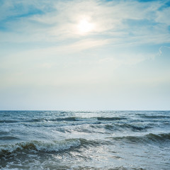 Obraz na płótnie Canvas stormy sea and dramatic sky with sun