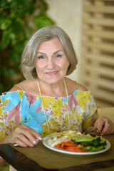 Senior woman eating breakfast