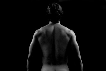 Studio photography of a man with His back, white and black