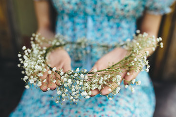 Girl holds head wreath in hands