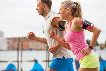 Woman and man running outdoors together