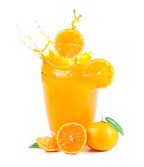splashing orange juice with oranges against white background
