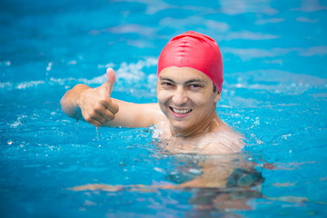 Fototapeta na wymiar water polo. polo player in a red rubber cap in the pool. 