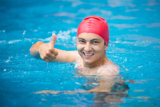 water polo. polo player in a red rubber cap in the pool. 
