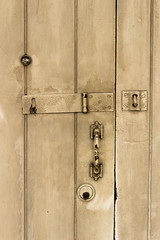 Fototapeta premium old wooden door with lock, handle, and eye hole.