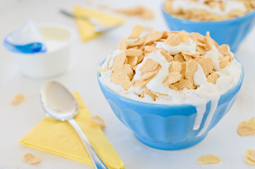 Corn cereals with greek yogurt in blue ceramic pot