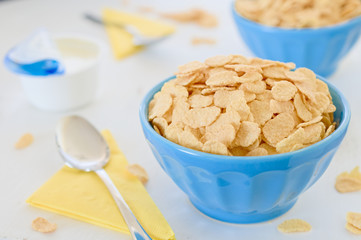 Corn cereals with greek yogurt in blue ceramic pot