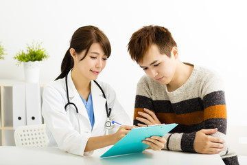 female doctor talking with  patient in  office