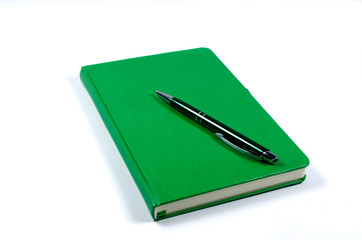Green notepad and pen, isolated on white