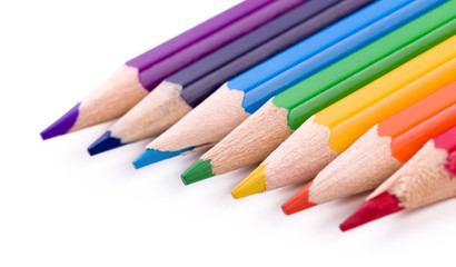 Many different colored pencils on white background