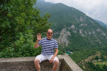Obraz premium Man is posing on canyon of Tara river background, Montenegro.