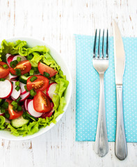 Spring salad with tomato, cucumbers and radish