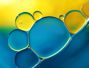 Abstract background with oil drops on water