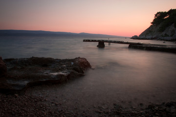 Sunset Beach with Piers and Wooden Breakwater with Late Sun Rays