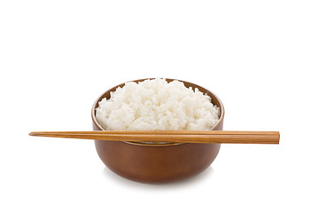 Fototapeta na wymiar Rice in bowl and chopsticks on white background