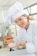 Female baker proud of her cake