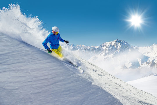 Man skier running downhill