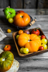Colorful heirloom tomatoes on rustic wooden background