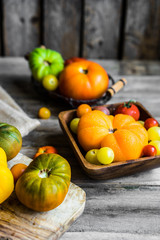 Colorful heirloom tomatoes on rustic wooden background