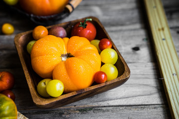 Colorful heirloom tomatoes on rustic wooden background