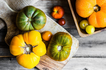 Colorful heirloom tomatoes on rustic wooden background
