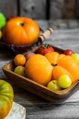 Colorful heirloom tomatoes on rustic wooden background