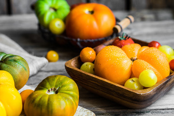 Colorful heirloom tomatoes on rustic wooden background