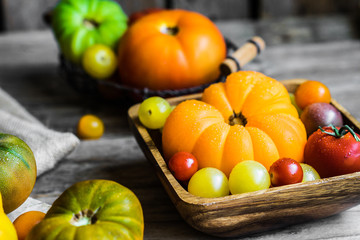 Colorful heirloom tomatoes on rustic wooden background