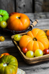 Colorful heirloom tomatoes on rustic wooden background