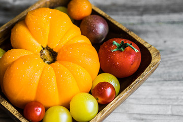 Colorful heirloom tomatoes on rustic wooden background