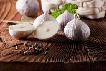 garlic, herbs and spices on wooden background
