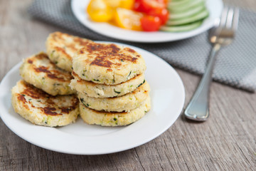 Vegetarian breakfast:  zucchini fritters made with coconut flour and a salad, selective focus