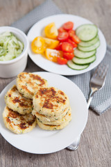 Vegetarian breakfast:  zucchini fritters made with coconut flour and a salad, selective focus