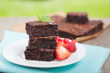 Healthy gluten free brownies made with sweet potato and coconut flour. Paleo style brownies on a wooden table, selective focus