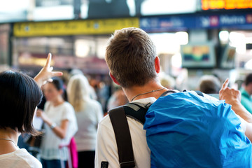 young backpacker asking indications