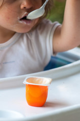 Baby eating yogurt