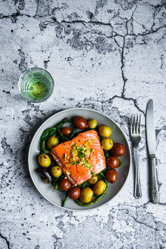 Grilled salmon with beans and potatoes on rustic background