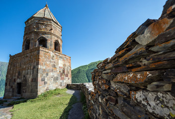 Fototapeta na wymiar 14th century Holy Trinity Church (Tsminda Sameba) near Mount Kazbek in Georgia