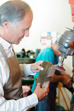 Shoemaker adjusting a heel