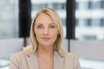 Portrait of businesswoman in modern office. Building in background