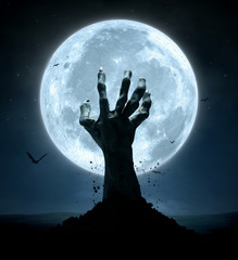 Halloween, zombie hand rising out of the grave