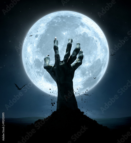 Halloween, zombie hand rising out of the grave