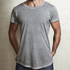 Muscular guy wearing grey t-shirt