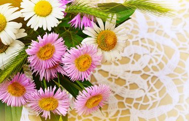 Summer flowers bouquet on crochet background