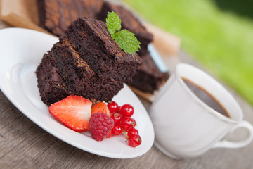 Healthy gluten free brownies made with sweet potato and coconut flour. Paleo style brownies on a wooden table, selective focus