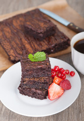Healthy gluten free brownies made with sweet potato and coconut flour. Paleo style brownies on a wooden table, selective focus