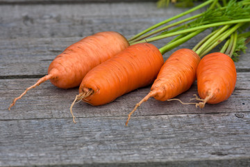 fresh carrots on the wooden table