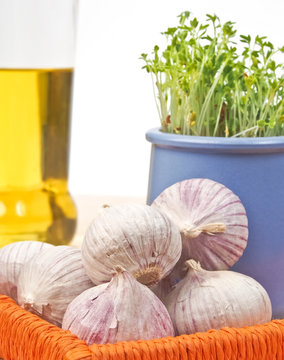 Garlic and cress with olive oil in background