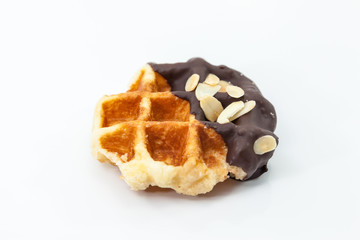 Waffles with chocolate and nut on white background.
